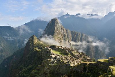 Panoramic view of mountains against cloudy sky