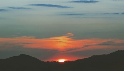 Scenic view of silhouette mountains against sky during sunset