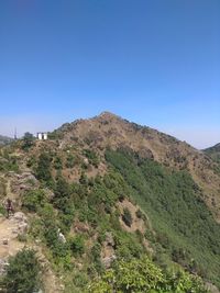 Scenic view of mountains against clear blue sky
