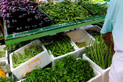 Midsection of woman working at market stall