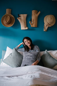 Portrait of woman lying on bed at home