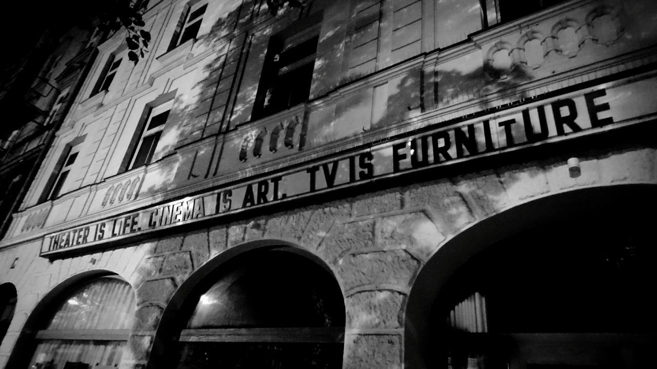 LOW ANGLE VIEW OF TEXT ON BRICK WALL