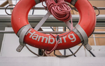 Close-up of life belt hanging on railing