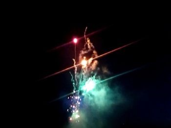 Low angle view of firework display at night