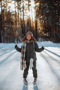 Full length of girl standing in snow