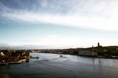 High angle view of river by buildings against sky