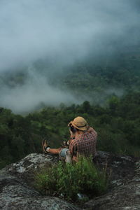 Woman looking at mountain against sky