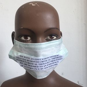 Close-up of mannequin with mask and quotes