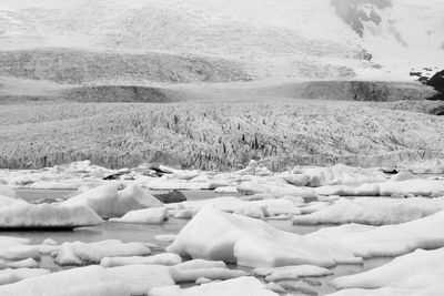 Low section of woman standing on snow covered landscape