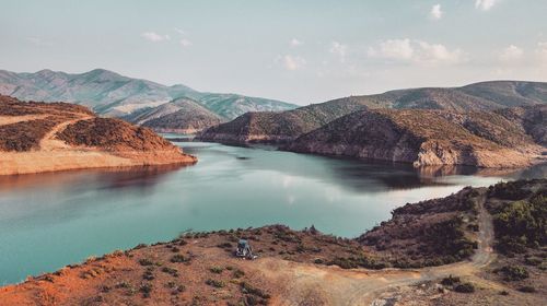 Scenic view of lake and mountains against sky