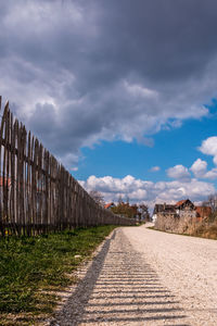 Empty road along buildings