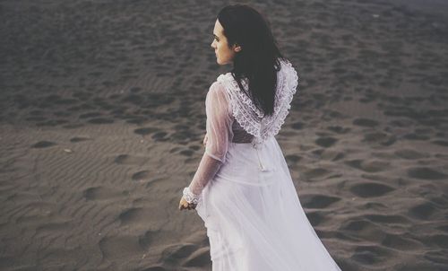 Side view of a young woman on beach