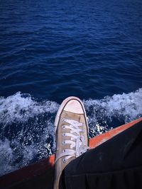 Low section of person on boat in sea