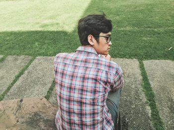 Full length of young man standing against wall