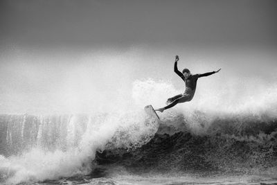 Full length of man jumping in sea