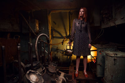 Woman standing in abandoned building