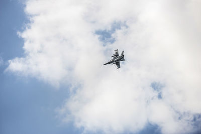 Low angle view of military airplane performing airshow against sky