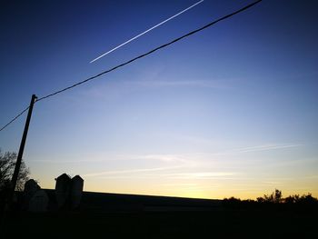 Low angle view of silhouette building against sky during sunset