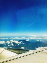 Scenic view of mountains against blue sky