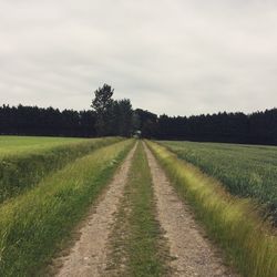 Empty road along countryside landscape