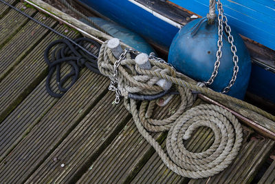 Close-up of rope tied to boat moored at harbor