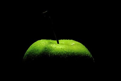 Close-up of apple against black background