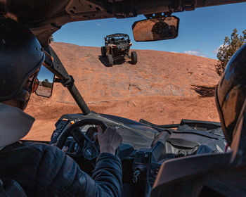 Full frame view of tourists enjoying a challenging 4x4 tour in rugged terrain on a sunny day