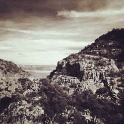 Scenic view of mountains against cloudy sky