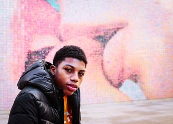 Portrait of young man against the kiss wall 