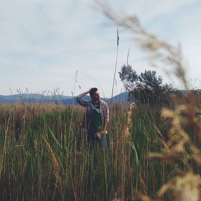 lifestyles, leisure activity, casual clothing, sky, full length, grass, person, field, childhood, plant, nature, boys, three quarter length, standing, tranquility, young adult, rear view, landscape
