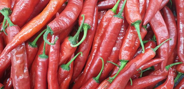 Full frame shot of red chili peppers for sale in market