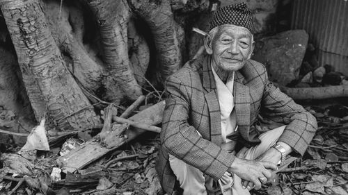 Portrait of woman sitting on tree