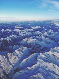 Aerial view of snowcapped mountains against sky