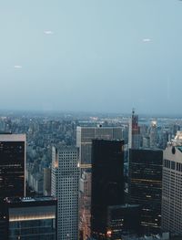 Illuminated cityscape against sky