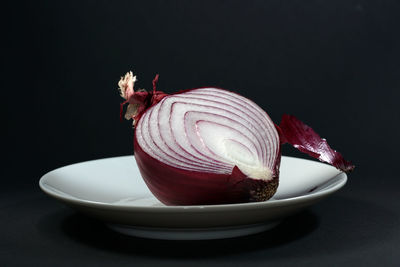 Close-up of dessert in bowl on table against black background