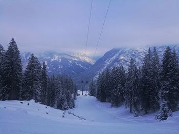 Scenic view of snow covered mountains against sky