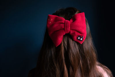 Portrait of woman wearing hair bow