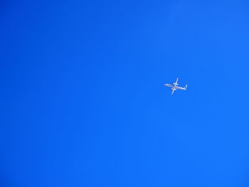 Low angle view of airplane flying in sky