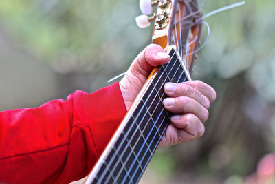 Midsection of person playing guitar