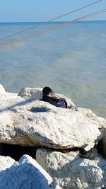 Full length of woman standing on rocks