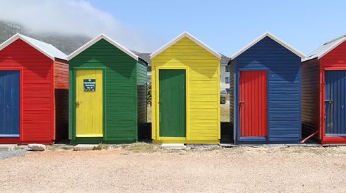 Colorful beach huts against blue sky