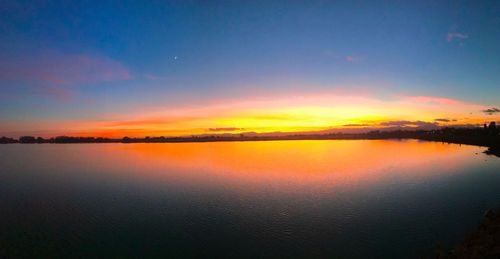 Scenic view of lake against sky during sunset