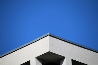 Low angle view of building against clear blue sky