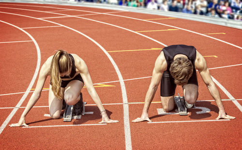 Athletes at starting line on running track