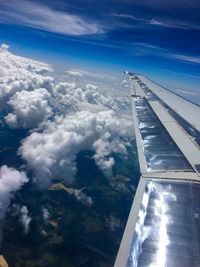Aerial view of airplane wing against sky