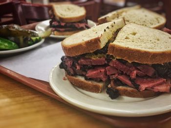 Pastrami sandwiches served in plates on table