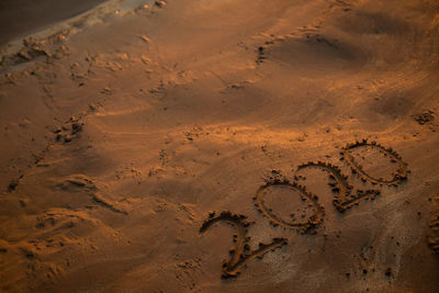 High angle view of text on sand at beach