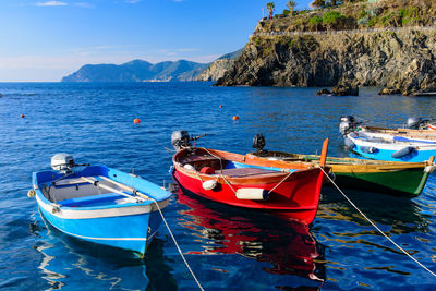 Boats moored on sea against sky