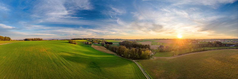 Panoramic view of field against sky during sunset