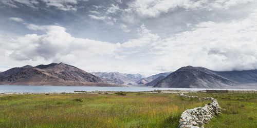 Scenic view of lake and mountains against sky